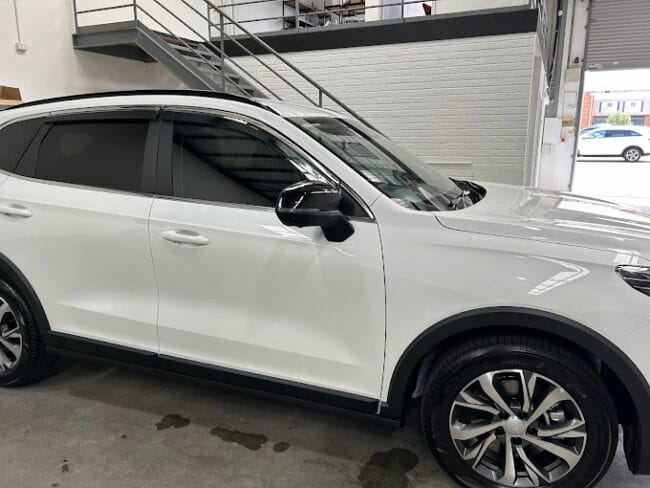 White SUV with dark window tint professionally installed – enhances privacy, reduces heat, and adds a premium look.